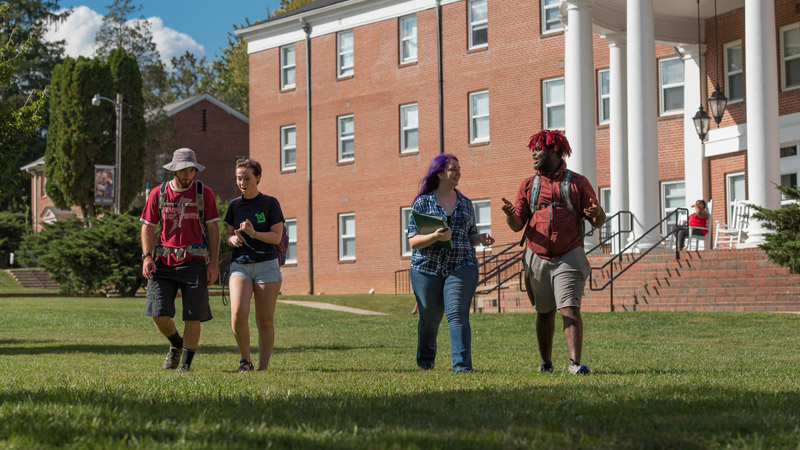 Outdoor photo of students walking and talking